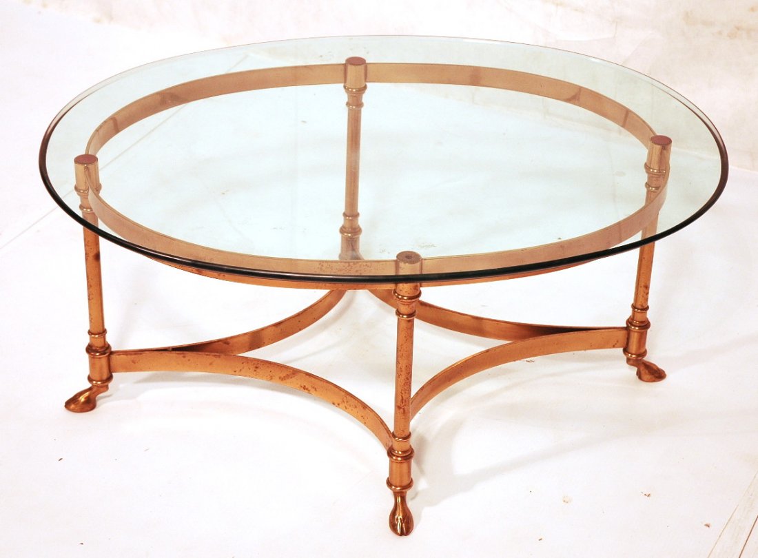 Oval Brass Frame Coffee Cocktail Table with Oval: Oval Brass Frame Coffee Cocktail Table with Oval Glass Top. Hoof feet.-- Dimensions: H: 15 inches: W: 34.5 inches: D: 26 inches ---