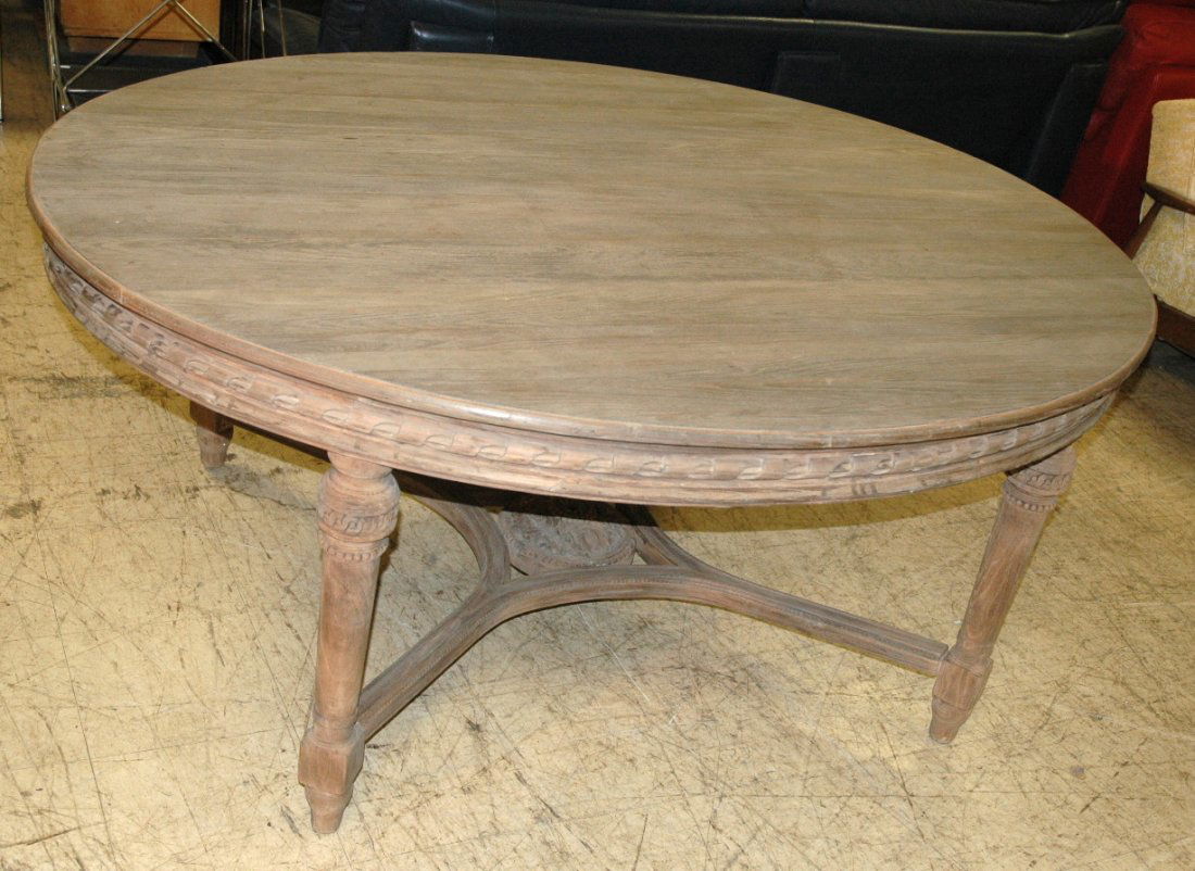 Italian Renaissance style Oval Wood Dining Table.: Italian Renaissance style Oval Wood Dining Table. Fancy carved Skirt and legs. Stretcher with carved center medallion.-- Dimensions: H: 31 inches: W: 71 inches: D: 57 inches ---