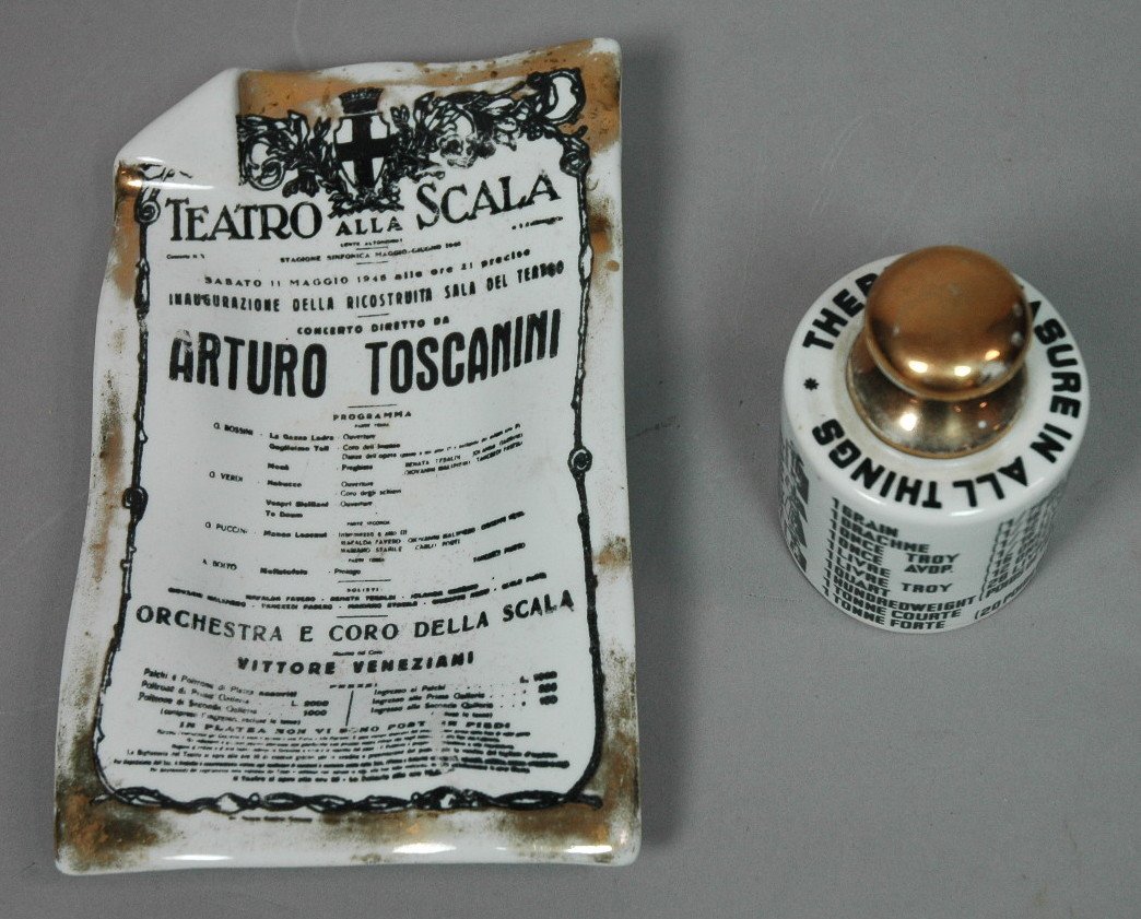 2pc PIERO FORNASETTI Milano Porcelain Lot. Insula: 2pc PIERO FORNASETTI Milano Porcelain Lot. Insulator paperweight with gilt finial. ARTURO TOSCANINI Poster from TEATRO Alla SCALA Dish. Dish marked. Insulator has Fornasetti green felt base, no stamp.