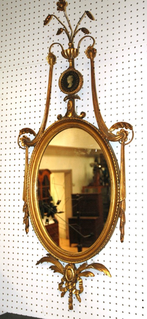 Antique Adams Style Oval Mirror. Drape and Ribbo: Antique Adams Style Oval Mirror. Drape and Ribbon design with hand painted cameo center. Edwardian. Carved wood and gesso.-- Dimensions: H: 48 inches: W: 20 inches ---