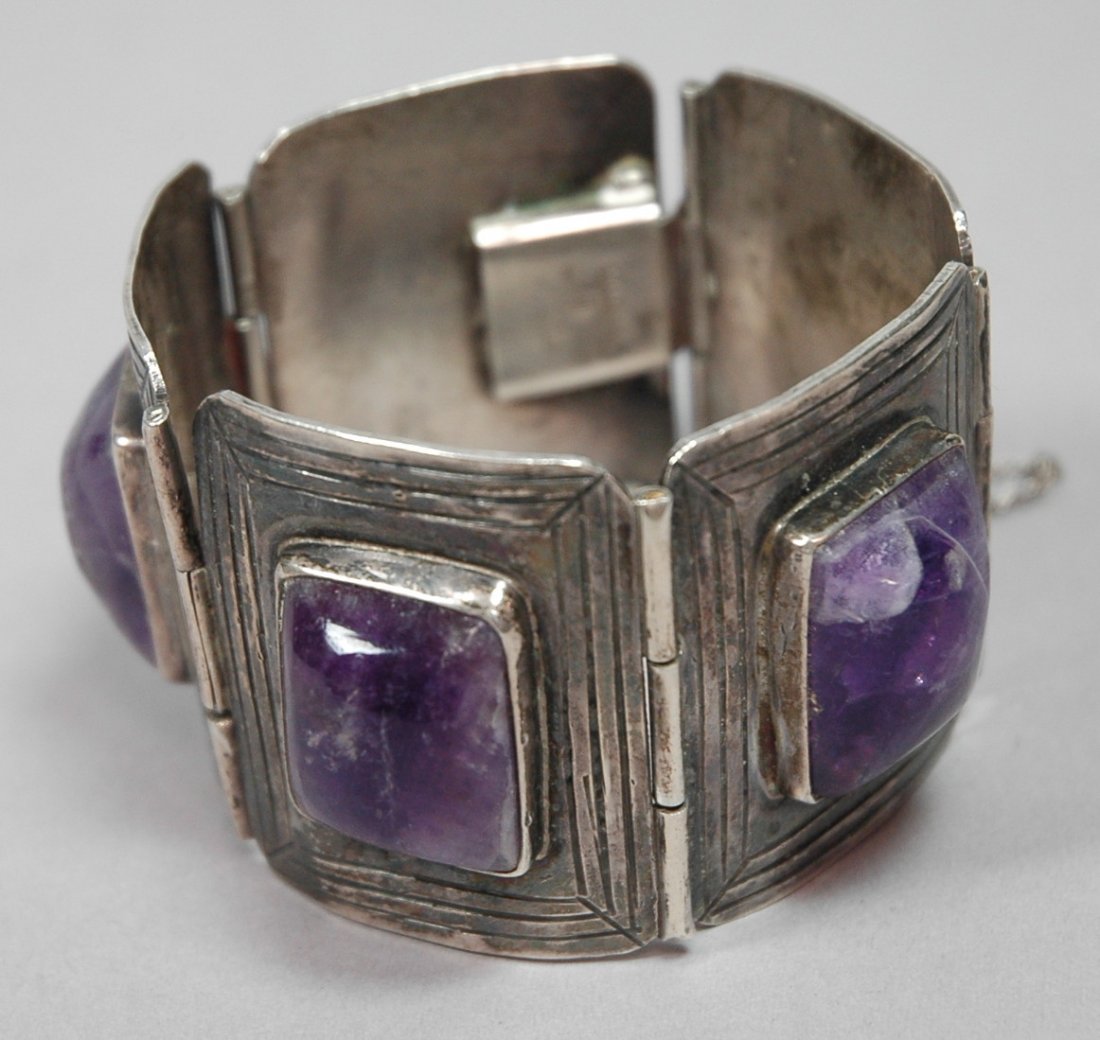 MELECIO RODRIQUEZ Sterling Amethyst Bracelet. Lar: MELECIO RODRIQUEZ Sterling Amethyst Bracelet. Large amethyst stones in 1.75" wide bracelet. Sterling Mexico marked MR. -- Dimensions: H: 1.75 inches: W: 7.25 inches --- US Shipping charge: $7
