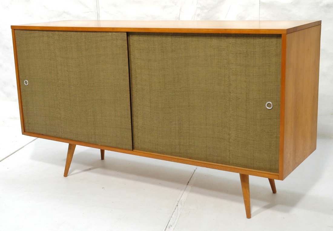 Paul McCobb Sideboard Credenza Cabinet. Planner: Paul McCobb Sideboard Credenza Cabinet. Planner Group. Tapered legs with grass cloth sliding doors. Interior drawers.-- Dimensions: H: 33.25 inches: W: 60 inches: D: 18.25 inches ---