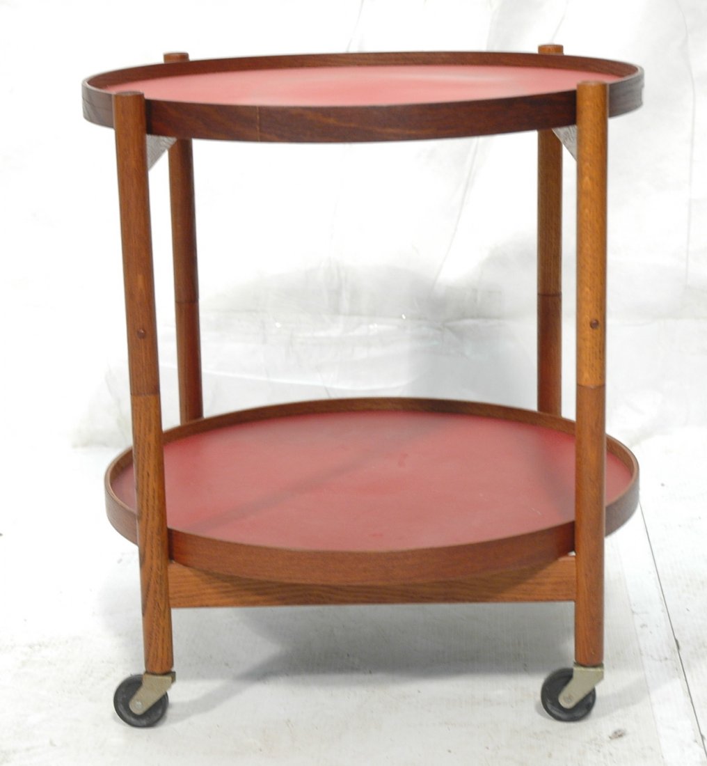 TROBEN ORSKOV Danish Modern Teak Two Tier Bar Cart.: TROBEN ORSKOV Danish Modern Teak Two Tier Bar Rolling Cart. Two round lift out trays lined in red. Remnants of paper label. -- Dimensions: H: 21.5 inches: W: 22 inches ---