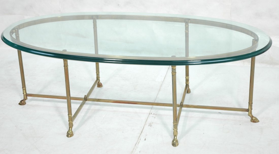Brass and Glass Coffee Table with Hoof Feet. 3/4: Brass and Glass Coffee Table with Hoof Feet. 3/4 inch glass. Heavy.-- Dimensions: H: 17.5 inches: W: 52 inches: D: 26 inches ---