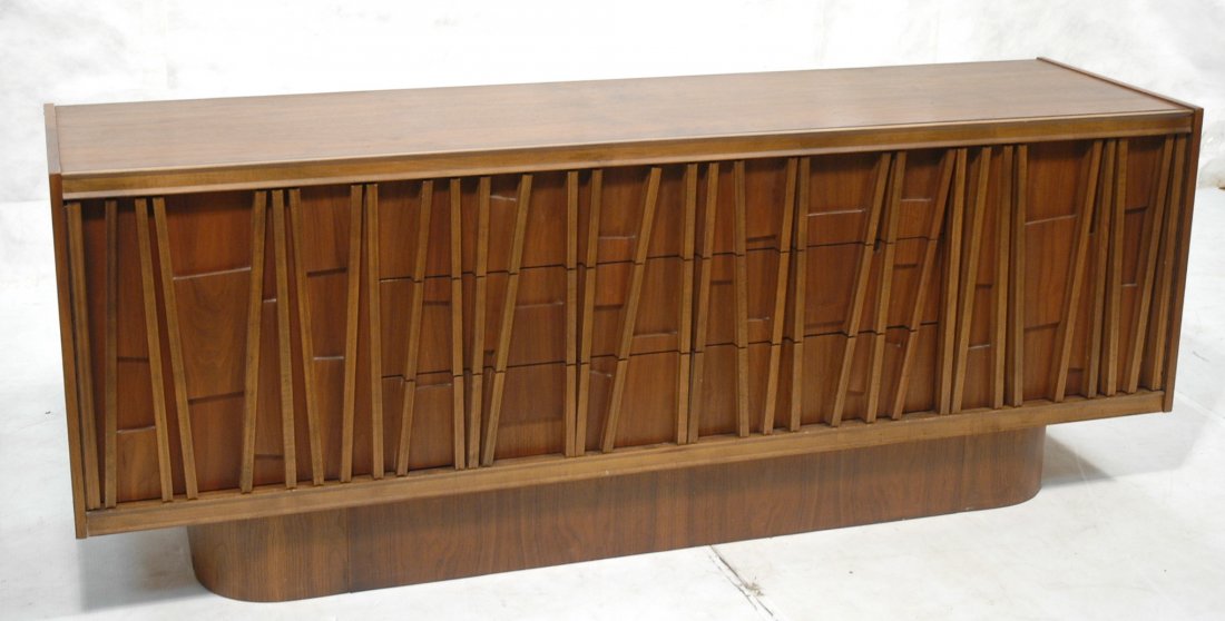 Sculptural front American Modern Walnut Credenza: Sculptural front American Modern Walnut Credenza Sideboard. Two doors with three center drawers. Interior shelves. Curved skirt base. -- Dimensions: H: 28.75 inches: D: 20 inches: L: 74.5 inches ---