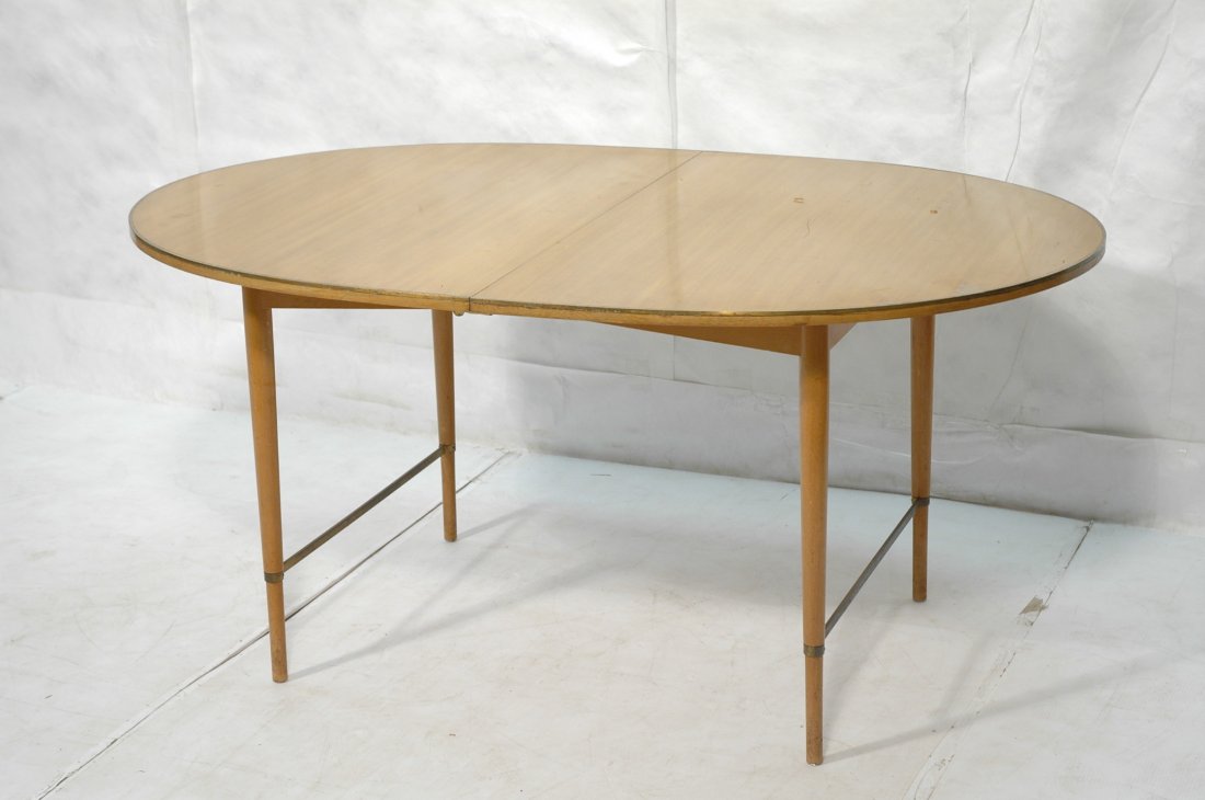 Paul McCOBB Brass Trimmed Oval Dining Table. Six: Paul McCOBB Brass Trimmed Oval Dining Table. Six 11" Leaves. Brass stretchers. Center leg. -- Dimensions: H: 29.25 inches: W: 62 inches: D: 41.25 inches ---