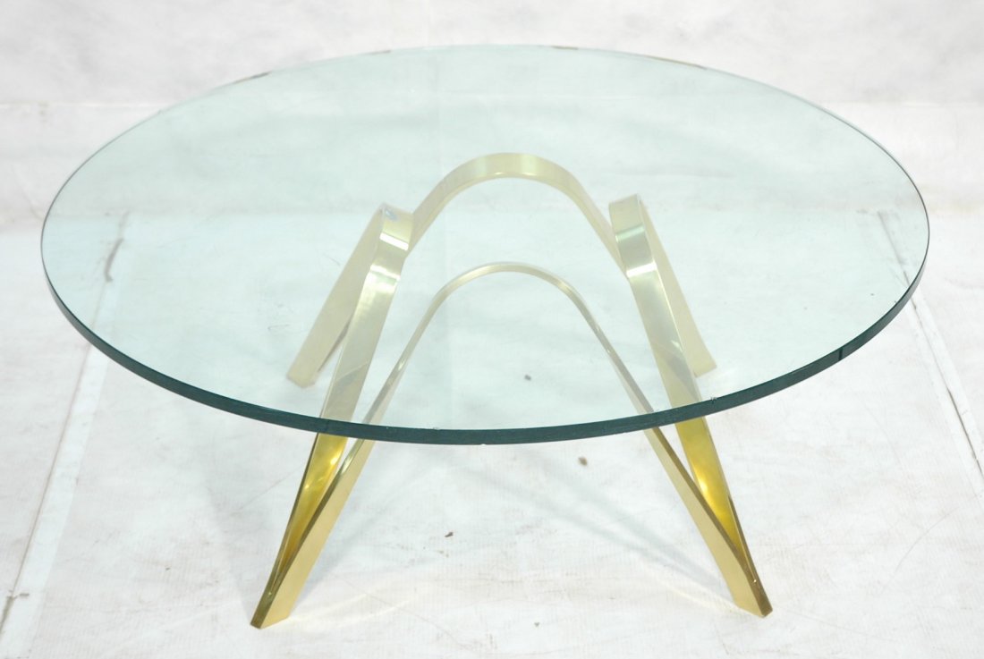 ROGER SPRUNGER style Glass Top Coffee Cocktail Ta: ROGER SPRUNGER style Glass Top Coffee Cocktail Table. Round glass on gold finish arched aluminum frame.-- Dimensions: H: 16 inches: W: 42 inches ---