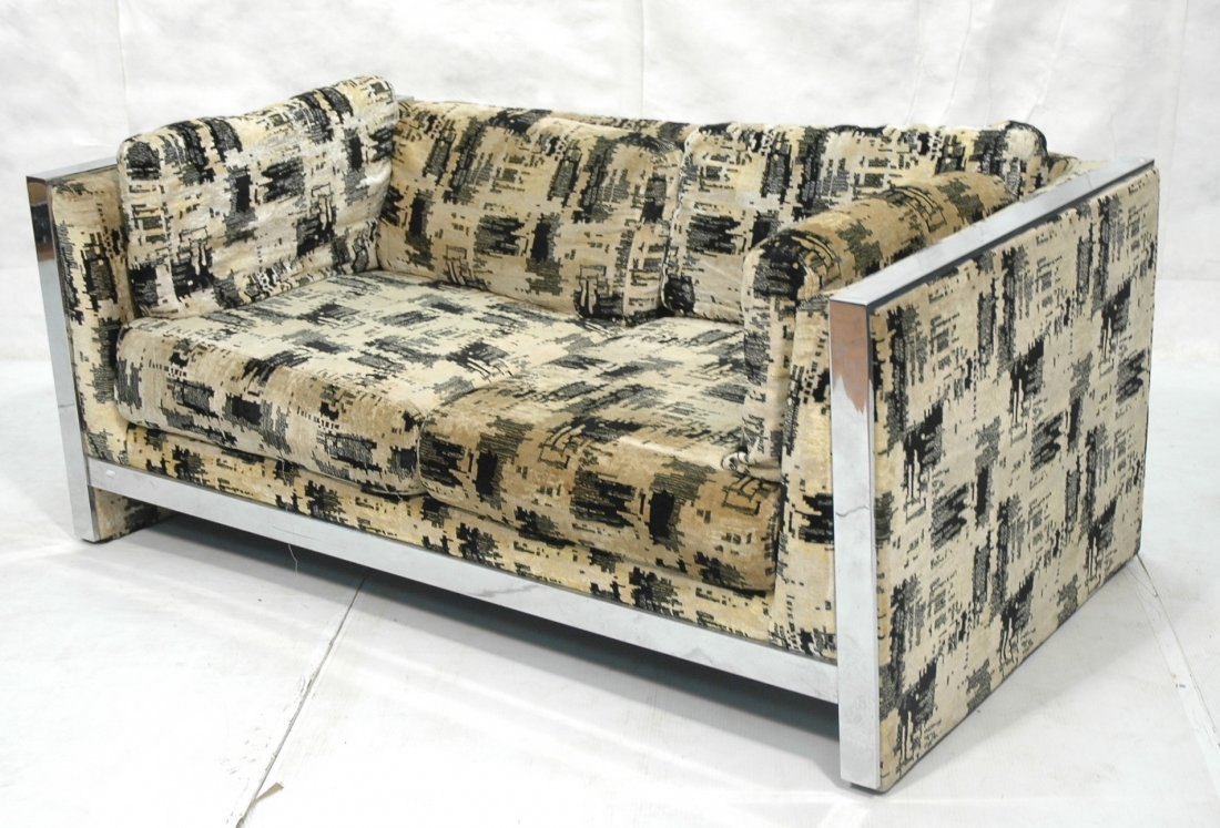 MILO BAUGHMAN style Chrome Fabric Love Seat. Wide: MILO BAUGHMAN style Chrome Fabric Love Seat. Wide flat chrome band frame. Cream, black, gray plush upholstery. Fabric tag Englander Triangle. -- Dimensions: H: 25.5 inches: W: 60 inches: D: 34 inches 