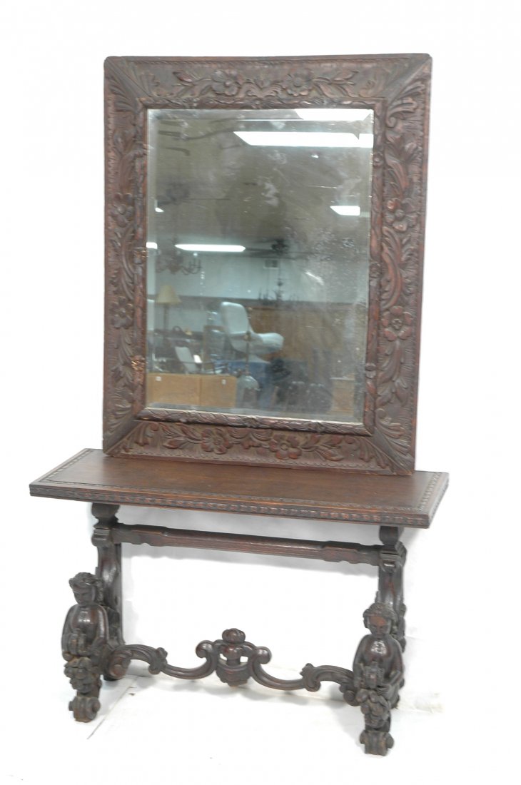 Continental Carved Wood Mirror and Hall Table. Fi: Continental Carved Wood Mirror and Hall Table. Figural carved. Wide carved wood frame. -- Dimensions: 2 separate pcs. mirror 42.5 x 35 base 26x42x15d