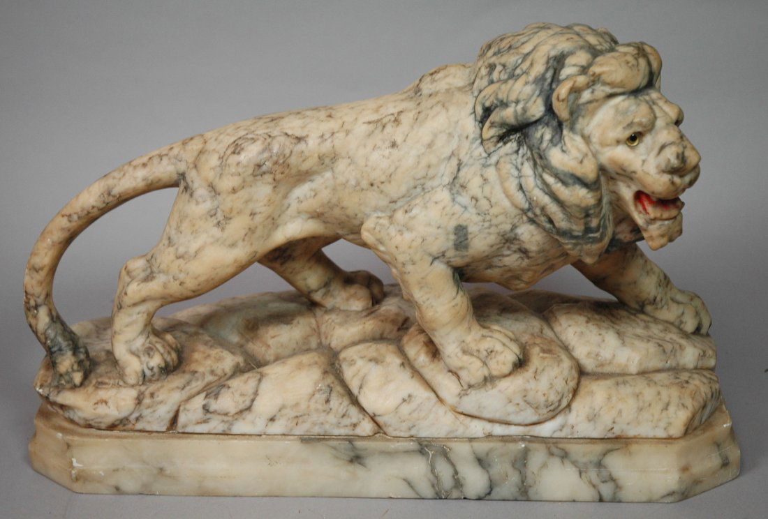 Carved Alabaster Lion Figure. Glass eyes.: Carved Alabaster Lion Figure. Glass eyes. -- Dimensions: H: 11 inches: W: 16.5 inches: D: 5.5 inches ---