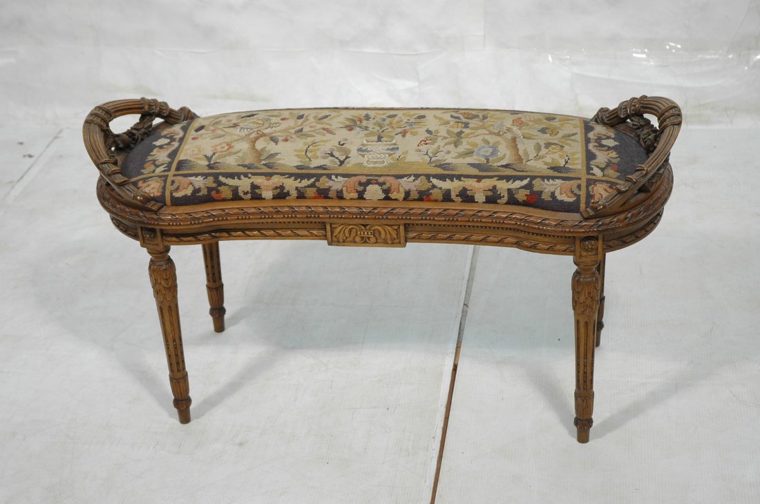 Carved French Needlepoint & Petite Point Bench. K: Carved French Needlepoint & Petite Point Bench. Kidney shape. Carved floral design. Reeded legs. -- Dimensions: H: 23.25 inches: W: 42 inches: D: 18 inches ---