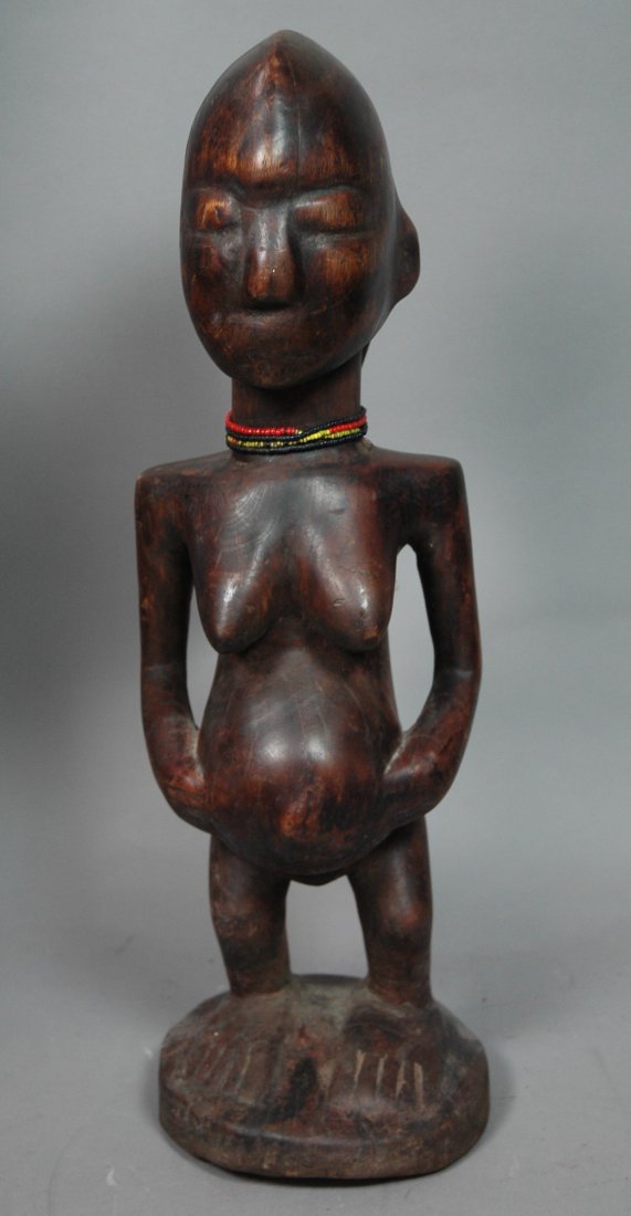 African Carved Wood Female Figure Sculpture Statu: African Carved Wood Female Figure Sculpture Statue. Woman with breasts and swollen belly. Glass bead accents-- Dimensions: H: 22 inches: W: 7 inches: D: 7 inches ---