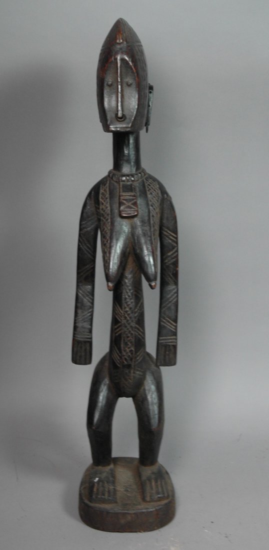 African Carved Wood Standing Female Figure Statue: African Carved Wood Standing Female Figure Statue Sculpture. Woman with detailed carving on face, breasts and belly. Carved wood necklace. Metal ring earrings.-- Dimensions: ---