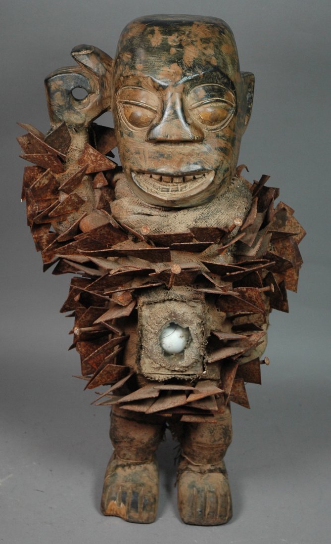 Carved African Wood Figure Statue. Covered in bur: Carved African Wood Figure Statue. Covered in burlap with metal triangles and nail accents. He's got personality.-- Dimensions: H: 26 inches: W: 14 inches ---