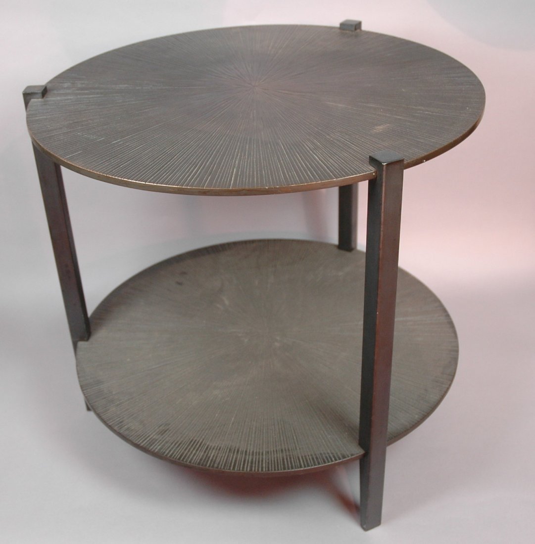 Round RAKOVA BRECKER Iron & Bronze Side Table. Ca: Round RAKOVA BRECKER Iron & Bronze Side Table. Cast bronze textured top. Patinated iron legs. Two round tiers. Marked with metal plate.-- Dimensions: H: 20.5 inches: W: 22 inches ---
