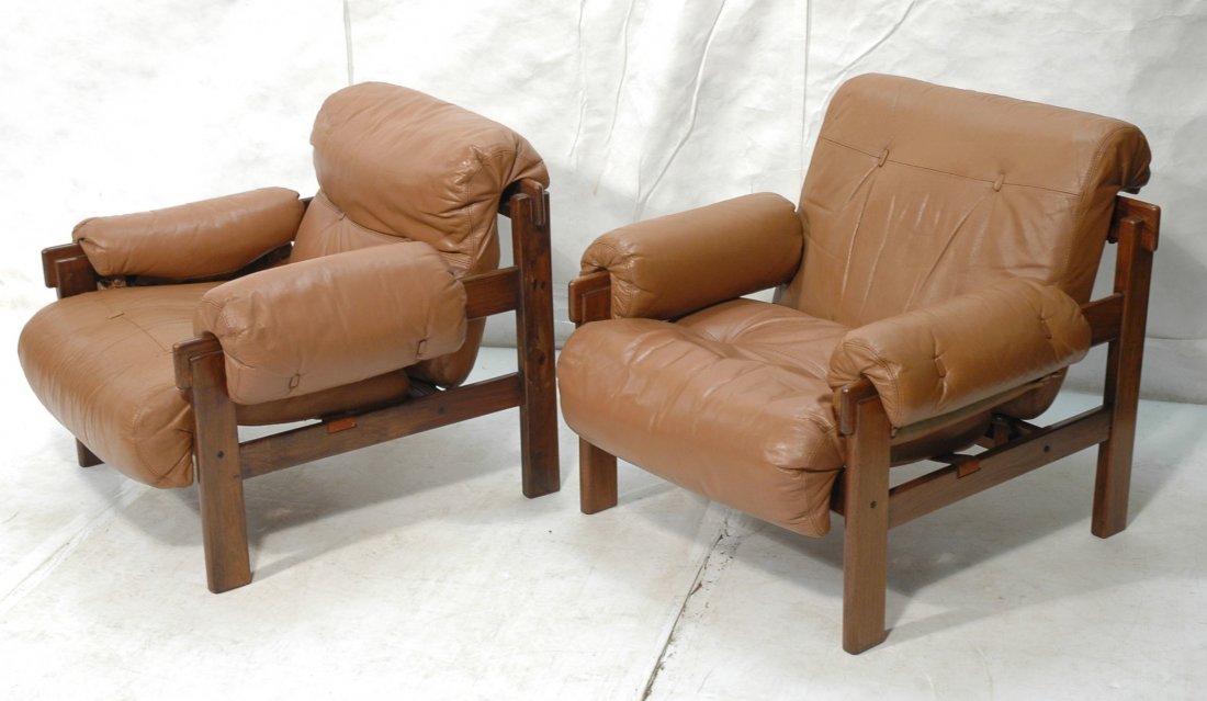Pr JEAN GILLON Leather Jacaranda Lounge Chairs. B: Pr JEAN GILLON Leather Jacaranda Lounge Chairs. Brown leather rolled arms, seat and back. Not marked. -- Dimensions: H: 30 inches: W: 38 inches: D: 34 inches ---
