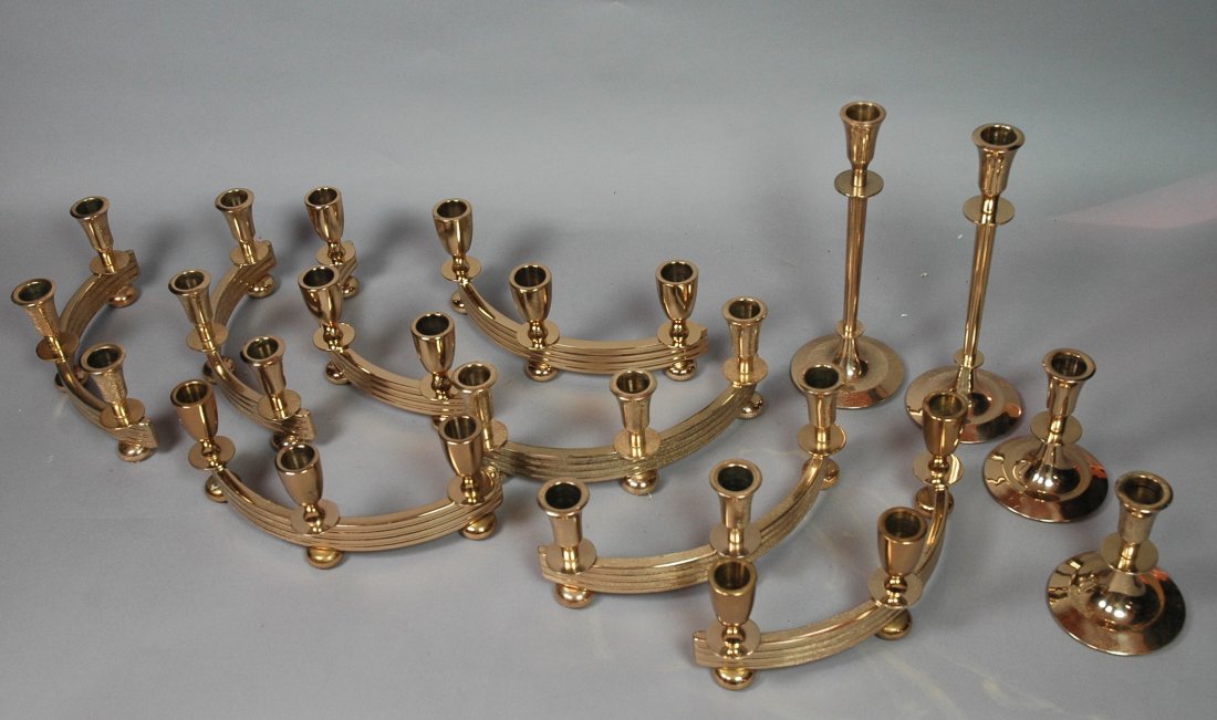 12pc Brass Candlesticks. Includes 8 arched 3 cand: 12pc Brass Candlesticks. Includes 8 arched 3 candle holders. Pr Tall Trumpet sticks. Pr short Trumpet sticks. All solid brass. TOMMI Parzinger style-- Dimensions: ---