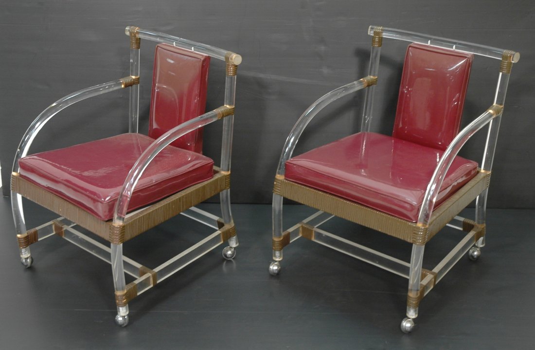 Pair Lucite and Rattan Lounge Chairs. Solid Tubu: Pair Lucite and Rattan Lounge Chairs. Solid Tubular acrylic frames. Rattan wrapping. On caspers.-- Dimensions: H: 33 inches: W: 23 inches: D: 27 inches ---