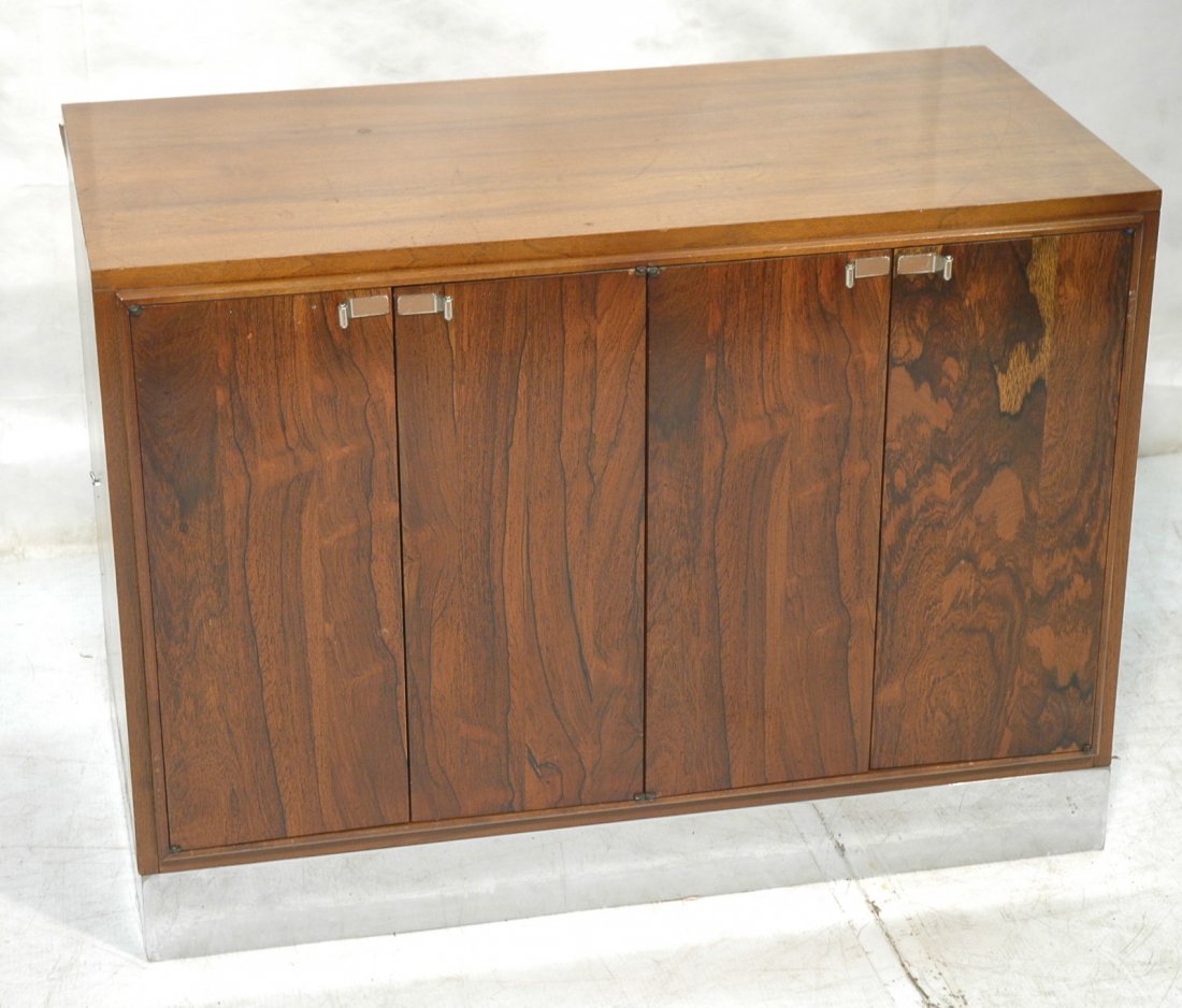 American Modern Rosewood & Walnut Cabinet. Four D: American Modern Rosewood & Walnut Cabinet. Four Door Cabinet with interior shelves. Walnut case with rosewood door fronts. Neat Art Deco chrome pulls. -- Dimensions: H: 29.5 inches: W: 40 inches: D: 2