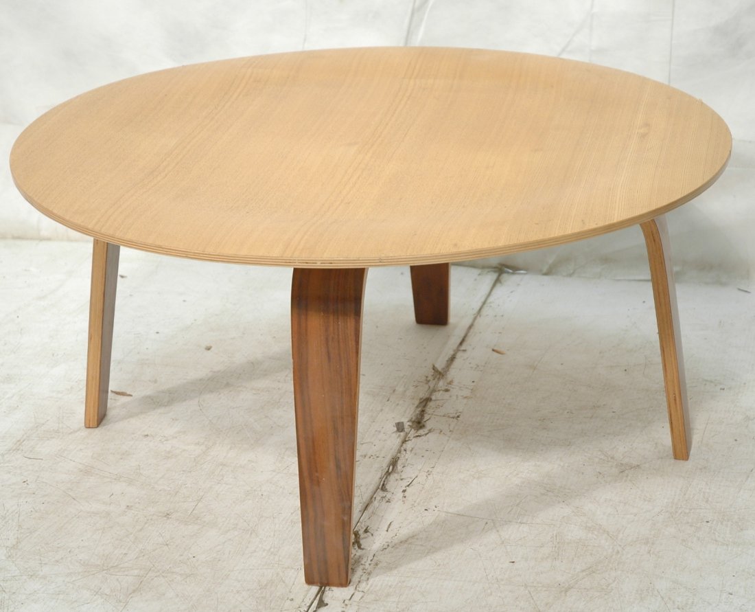 Round molded plywood Repro cocktail coffee table: Round molded plywood Repro cocktail coffee table. Low table. Laminated wood legs support circular top. Made in China Charles Eames repro. -- Dimensions: H: 16 inches: W: 34 inches ---