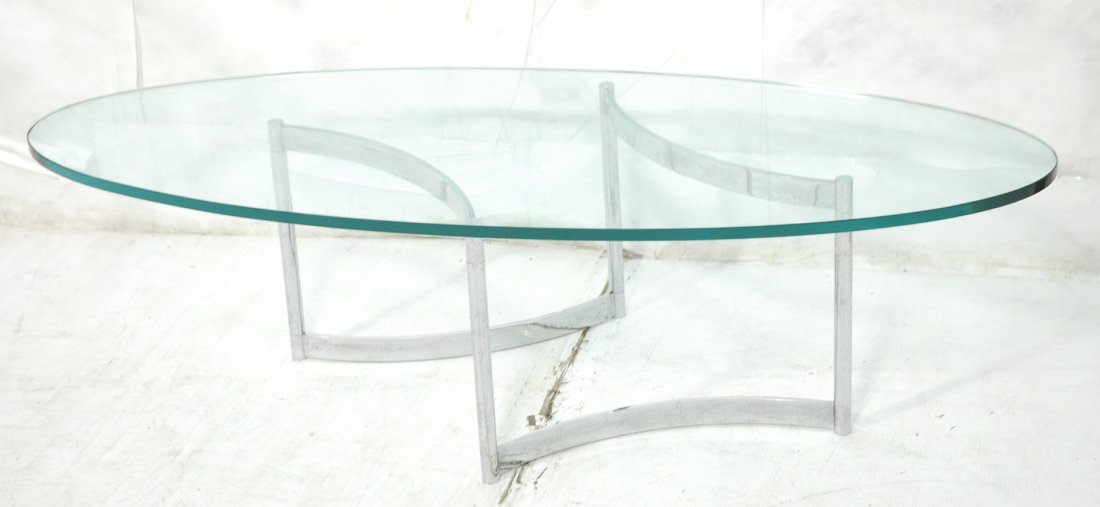 70's Modern Chrome & Glass Coffee Cocktail Table.: 70's Modern Chrome & Glass Coffee Cocktail Table. 3/4" thick oval glass on chrome base.-- Dimensions: H: 16 inches: W: 59.5 inches: D: 24 inches ---