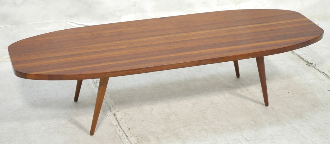 American Modern Walnut Coffee Cocktail Table. Sur: American Modern Walnut Coffee Cocktail Table. Surfboard shaped top on tapered legs.-- Dimensions: H: 14.25 inches: W: 61 inches: D: 21 inches ---