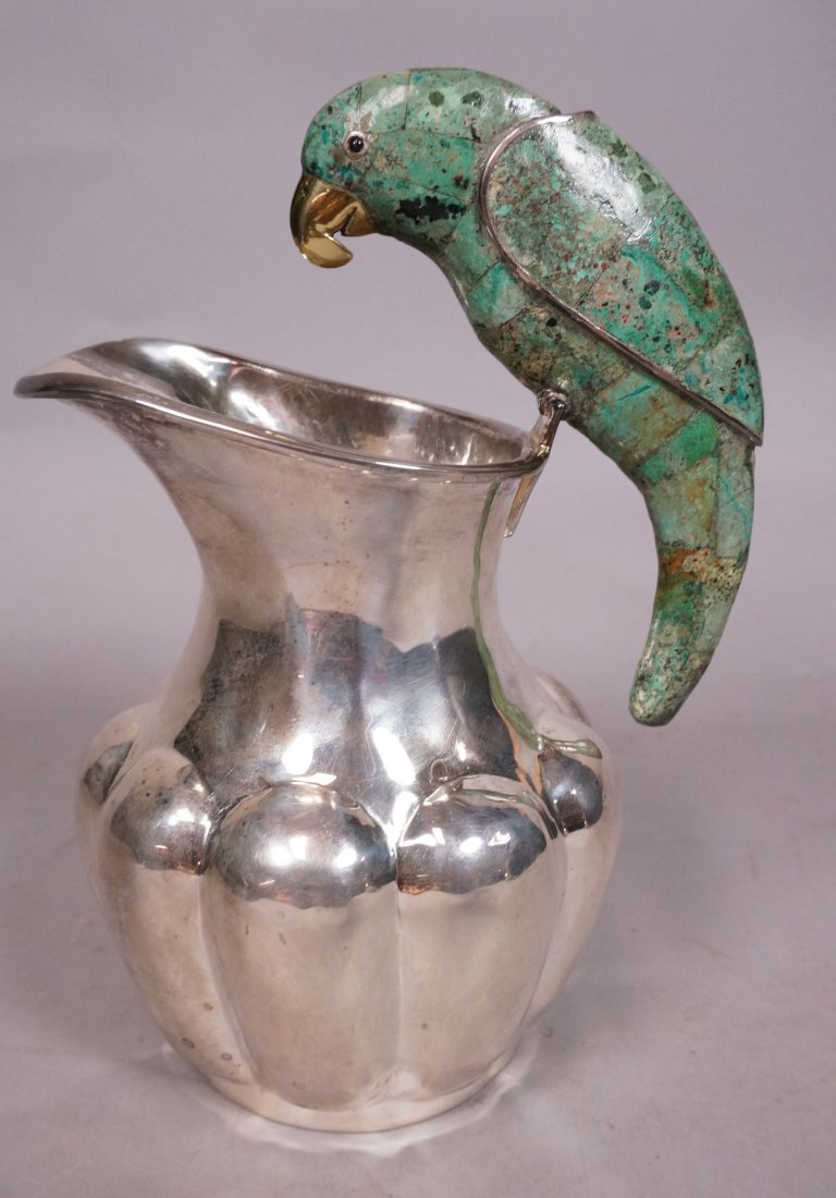 Los Castillo Hammered Silver Pitcher with Parrot.: Los Castillo Hammered Silver Pitcher with Parrot. Melon form with Turquoise Parrot handle. Brass beak.-- Dimensions: H: 8 inches: W: 4.5 inches --- US Shipping charge: $20
