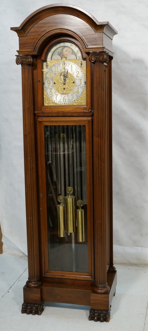 Matt. Bauerle Germany Grandfather Clock. Carved: Matt. Bauerle Germany Grandfather Clock. Carved mahogany case. 13 Tubes. Column front.-- Dimensions: H: 91 inches: W: 29 inches: D: 20 inches ---