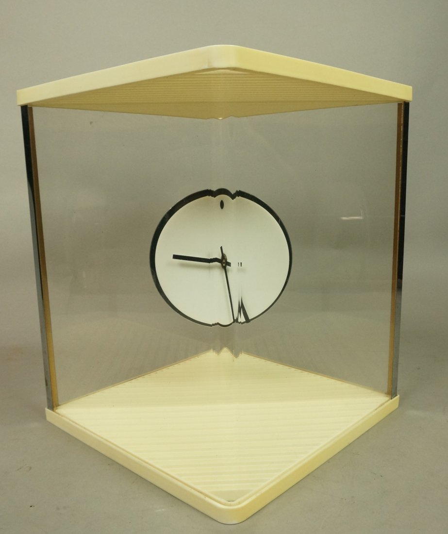 Modernist Mystery Clock. Round Clock Appears to b: Modernist Mystery Clock. Round Clock Appears to be suspended in Lucite box. Battery operated. Very clever. Raymor Label.-- Dimensions: H: 12 inches: W: 10 inches: D: 10 inches ---
