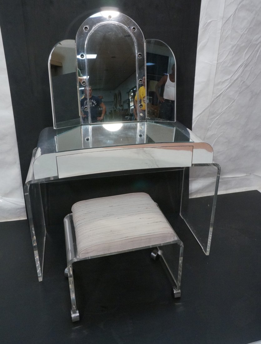 Lucite & Chrome Finish Vanity with Trifold Mirror: Lucite & Chrome Finish Vanity with Trifold Mirror. WITH Lucite Vanity Bench. Plastic chrome finish. -- Dimensions: H: 54.25 inches: W: 40 inches: D: 21 inches ---