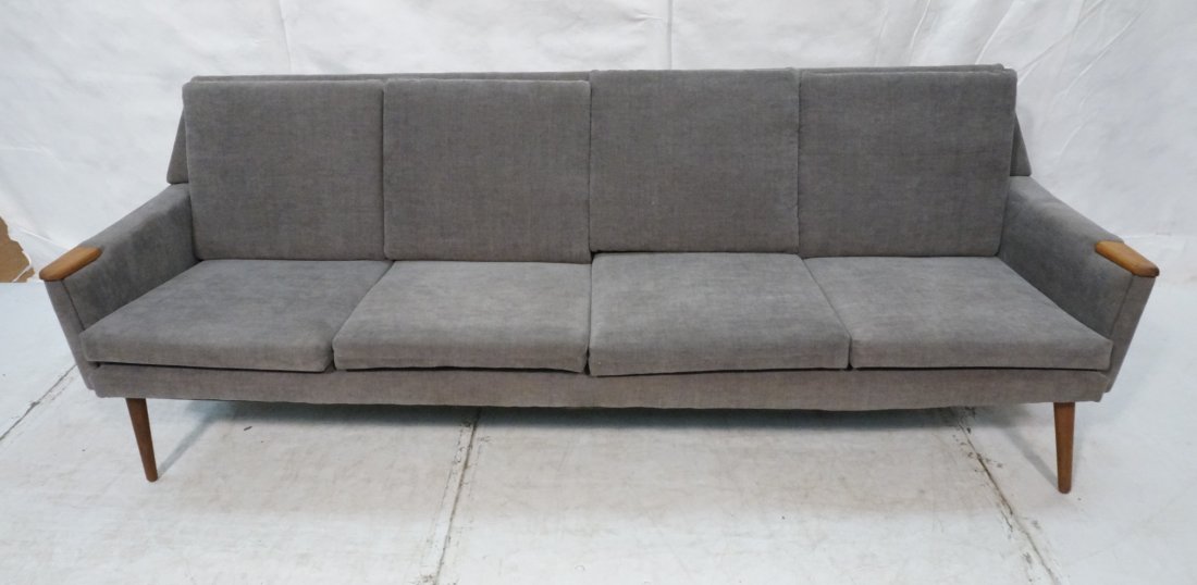 Long Modernist Four Seater Sofa Couch. Teak armre: Long Modernist Four Seater Sofa Couch. Teak armrest. Gray upholstery. Not marked-- Dimensions: H: 30.5 inches: D: 32 inches: L: 91 inches ---