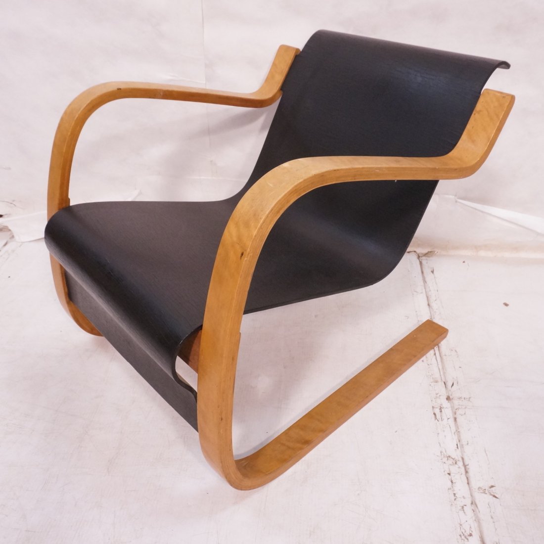 Early ALVAR AALTO Cantilever Lounge Chair, Model: Early ALVAR AALTO Cantilever Lounge Chair, Model 31/42. Finland. Black plywood seat; laminated birch frame.Leg Stamped 216. -- Dimensions: H: 24.25 inches: W: 24 inches: D: 30 inches ---