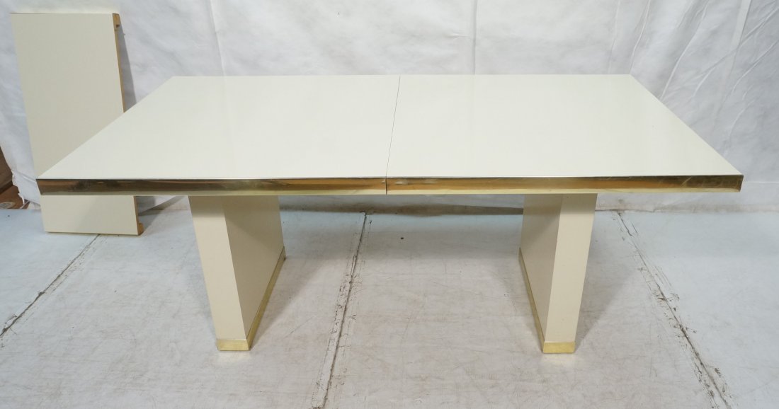 PIERRE CARDIN Dining Table. White Lacquer. Brass: PIERRE CARDIN Dining Table. White Lacquer. Brass finish metal trim. One 18" leaf. Marked.-- Dimensions: H: 29.5 inches: W: 72 inches: D: 38 inches ---