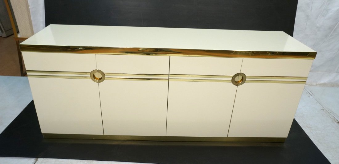 PIERRE CARDIN White Lacquer Sideboard Credenza. B: PIERRE CARDIN White Lacquer Sideboard Credenza. Brass tone metal finish trim & accents. Four doors with interior drawers & shelves. Marked-- Dimensions: H: 30.25 inches: W: 74.25 inches: D: 19.25 inch