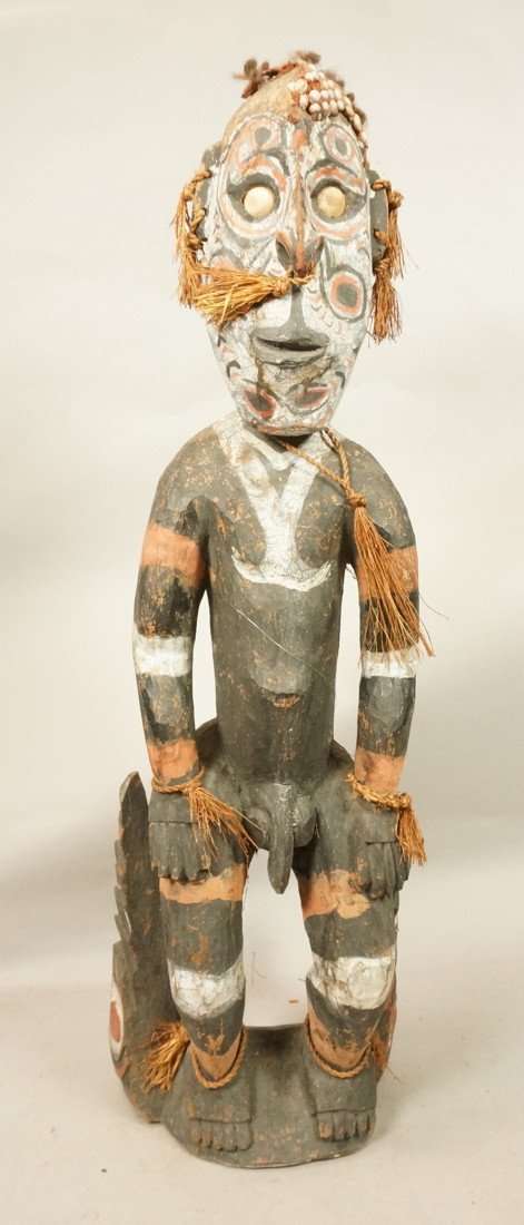 Carved African Wood Figure. Tribal Man. Painted s: Carved African Wood Figure. Tribal Man. Painted sculpture with braided raffia & seashells trim.-- Dimensions: H: 30 inches: W: 9 inches: D: 6.5 inches ---
