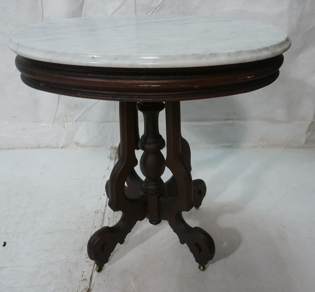 Victorian Walnut Marble Top Table. Oval Table wit: Victorian Walnut Marble Top Table. Oval Table with beveled marble.-- Dimensions: H: 30 inches: W: 29 inches: D: 21.75 inches ---