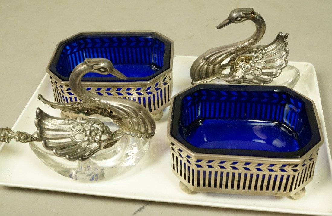 4pc Sterling Table Lot. 1. Two Sterling Swans wit: 4pc Sterling Table Lot. 1. Two Sterling Swans with divided crystal salt & pepper bowl; German. 2. Pr Pierced Sterling Salts with Cobalt Glass Liners. Marked sterling 3651/63.-- Dimensions: H: 2.75 inc