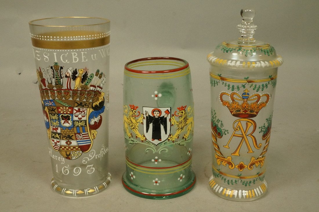 3pc Hand Painted Enameled Bavarian German Drink Set: 3pc Hand Painted Bavarian German Drink Set. One handled. Two Tumblers; one with lid. Raised enamel paint decorated. One with coat of arms dated 1693. -- Dimensions: H: 8 inches: W: 3.5 inches ---