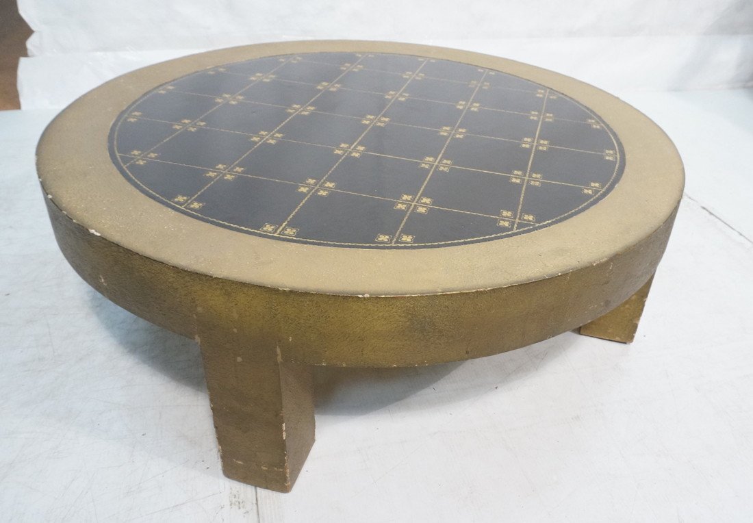 JAMES MONT Coffee Cocktail Table. Gold decorated: JAMES MONT Coffee Cocktail Table. Gold decorated wide frame with embossed gilt decorated black leather top. Textured gold frame. Branded James Mont.-- Dimensions: H: 14 inches: W: 41.5 inches: D: 41.5