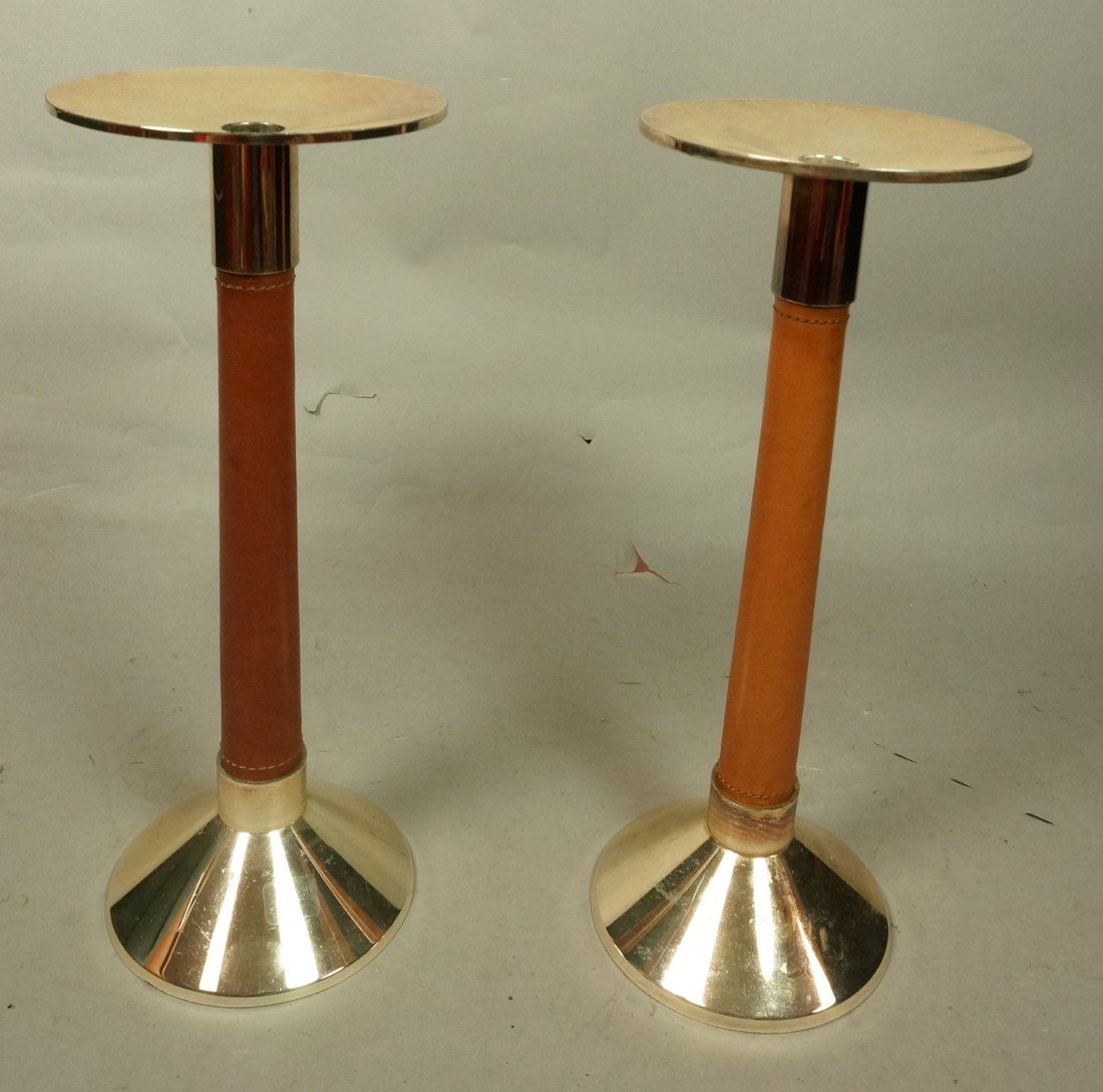 Pair Ralph Lauren Leather Rapped Candlesticks. G: Pair Ralph Lauren Leather Rapped Candlesticks. Gold tone metal with leather rapped columns.-- Dimensions: H: 14 inches: W: 5.5 inches ---