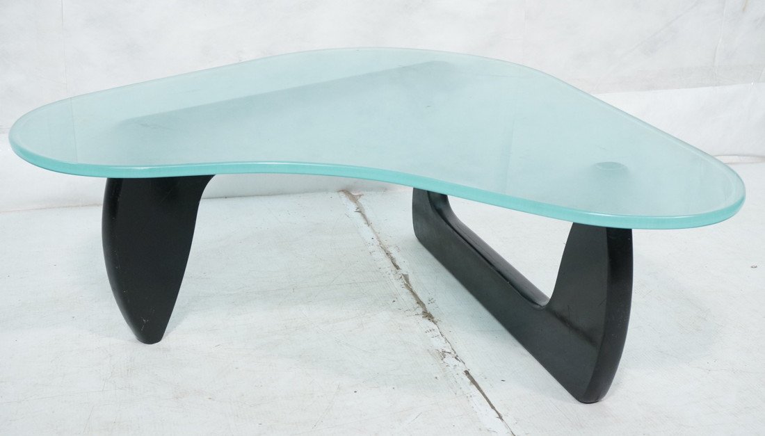 Frosted Glass Modernist Wood Cocktail Table. 3/4": Frosted Glass Modernist Wood Cocktail Table. 3/4" thick biomorphic shaped frosted glass top. NOGUCHI ebonized wood base. -- Dimensions: H: 16 inches: W: 43 inches: D: 40.5 inches ---