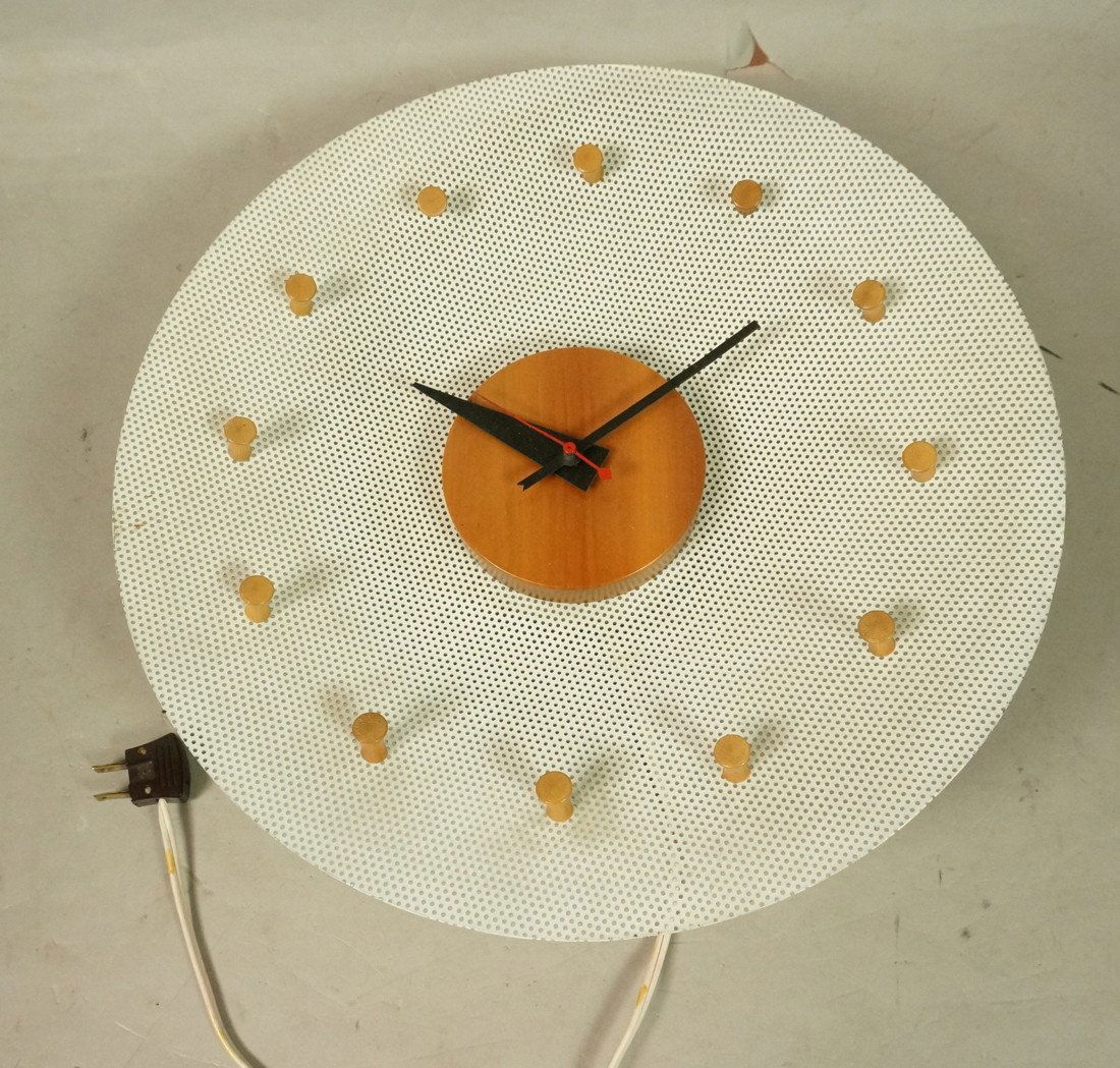 GEORGE NELSON Wall Clock. HERMAN MILLER. Circular: GEORGE NELSON Wall Clock. HERMAN MILLER. Circular White Mesh with light wood disc center and pegs. Iconic black metal hands. Howard Miller label. Model #2204.-- Dimensions: H: 14 inches: W: 14 inches:
