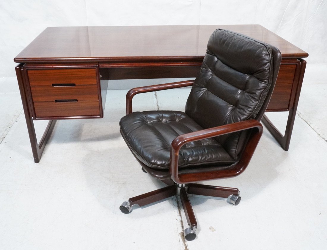 DYRLUND Danish Rosewood Desk & Office Chair. Four: DYRLUND Danish Rosewood Desk & Office Chair. Four drawers. Rosewood Chair with Chocolate Leather Upholstery. Desk & chair both marked Dyrlund. -- Dimensions: H: 29 inches: D: 35 inches: L: 70 inches -