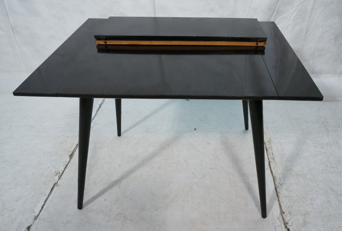 Black Lacquer PAUL McCOBB Table. Two pull out edg: Black Lacquer PAUL McCOBB Table. Two pull out edges for 92) 10" leaves. Marked.-- Dimensions: H: 28 inches: W: 29.5 inches: D: 40 inches ---