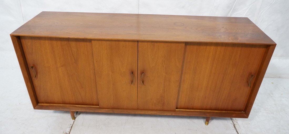 Modernist Teak Danish Credenza. Four Sliding Door: Modernist Teak Danish Credenza. Four Sliding Doors. Raised on legs. Metal pulls. Has pull out bar shelf-- Dimensions: H: 29 inches: W: 69 inches: D: 17.5 inches ---