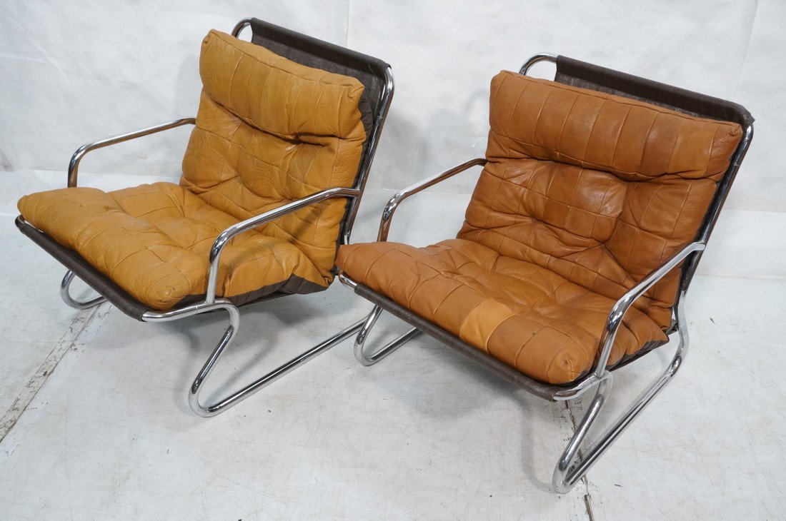 Pr 70's Modern Chrome & Leather Lounge Chairs. P: Pr 70's Modern Chrome & Leather Lounge Chairs. Patchwork leather cushions. Tubular chrome frame.-- Dimensions: H: 27.25 inches: W: 23 inches: D: 26 inches ---