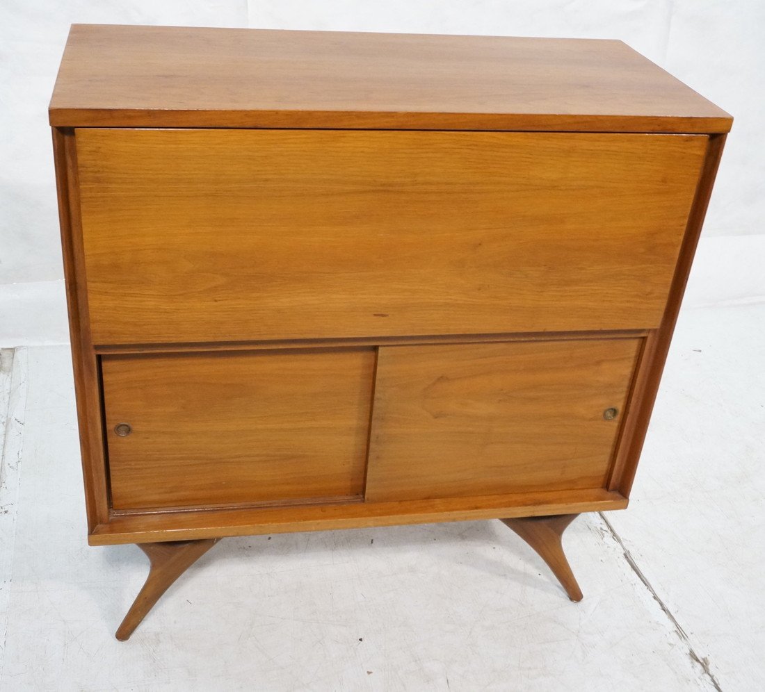 American Modern Walnut Drop Front Bar Cabinet. In: American Modern Walnut Drop Front Bar Cabinet. Interior with mirror back and fitted for glasses & bottles. Raised on Pearsall style legs. -- Dimensions: H: 37.75 inches: W: 36 inches: D: 16 inches ---