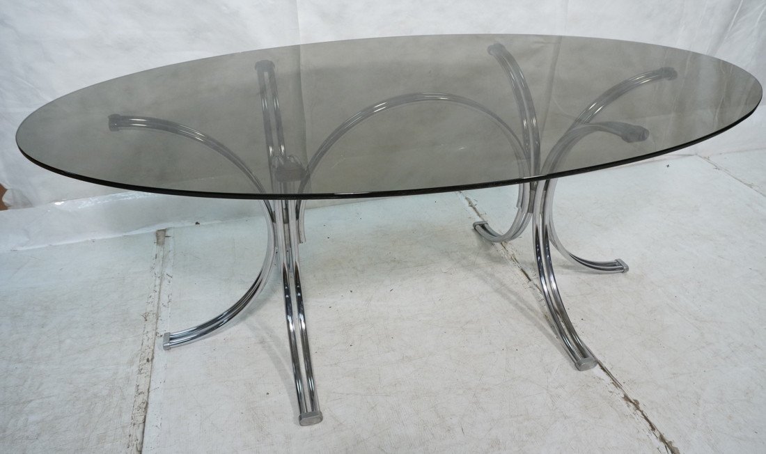 70's Modern Chrome & Glass Dining Table. Oval Smo: 70's Modern Chrome & Glass Dining Table. Oval Smoked Glass on chrome base.-- Dimensions: H: 28.75 inches: W: 74.5 inches: D: 42.5 inches ---