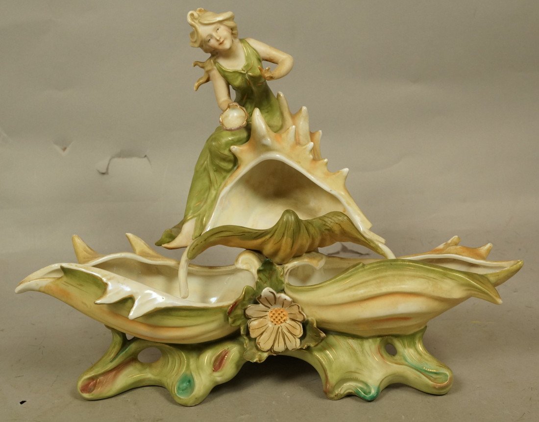 AMPHORA Porcelain Figural Group. Art Nouveau Woma: AMPHORA Porcelain Figural Group. Art Nouveau Woman sits on shell form base. Not marked. -- Dimensions: H: 10 inches: W: 12.75 inches: D: 6 inches ---
