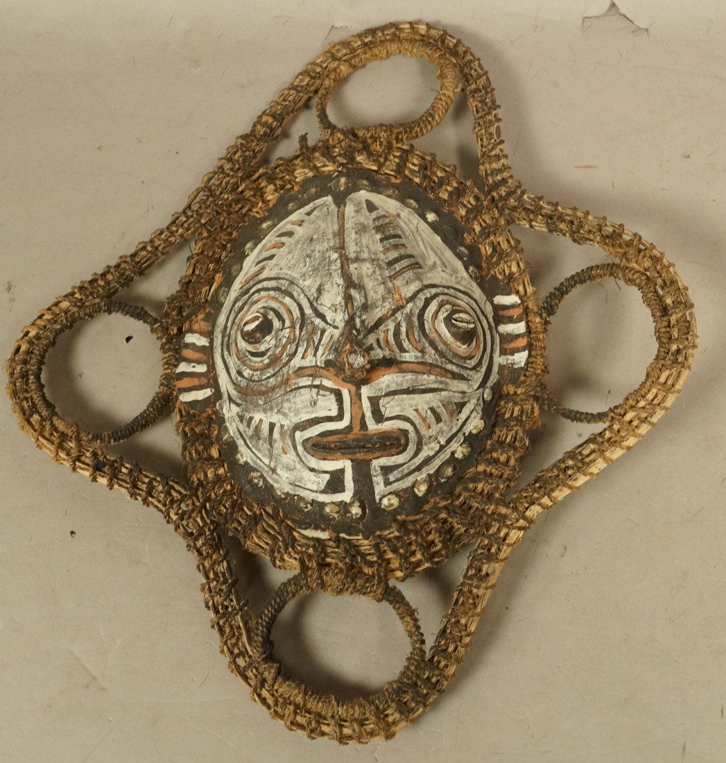 African Mask made with Turtle Shell. Woven Textil: African Mask made with Turtle Shell. Woven Textile webbed trim. Painted face on turtle shell with cowry shell details.-- Dimensions: H: 16 inches: W: 14 inches: D: 3 inches --- US Shipping charge: $20